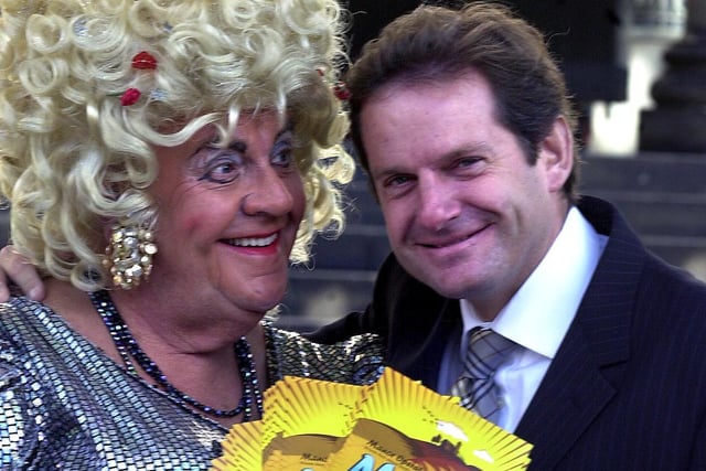 Brian Platts as Mother Goose and Anthony Hinchliffe of Ant Marketing, event sponsor, with free tickets for disadvantaged children for the Manor Operatic Society pantomime in Sheffield in 2003