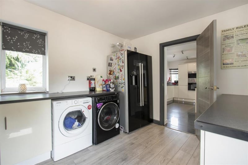 A separate utility room boasts space for a washing machine, tumble dryer and American-style fridge-freezer.