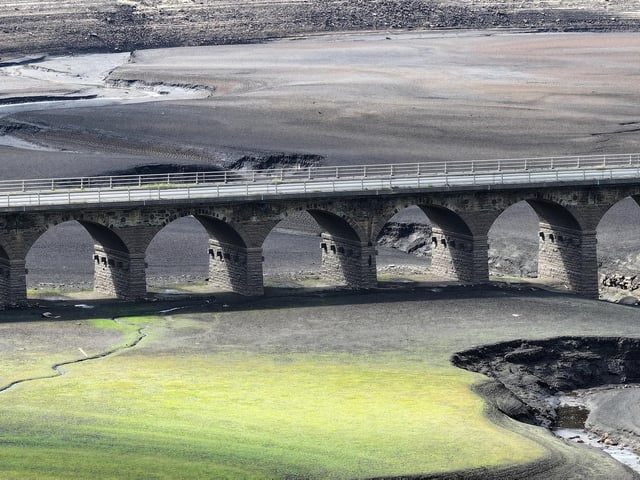 Water has dropped to critically low levels amid ongoing drought conditions revealing an extensively exposed and cracked bed.