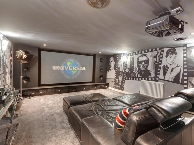 The snug private cinema provides a wonderful hideaway to relax and enjoy some entertainment, and benefits from a built-in surround sound system, an Optoma projector and recessed lighting.