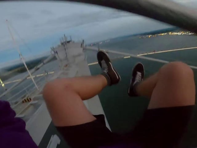 A film of the stunt shows the climbers scaling one of the tower's cables with just two wires on either side for support.