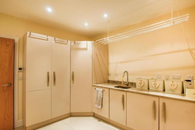 The utility room is the perfect space for doing the washing and even includes a second built in dishwasher.