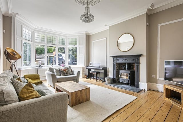 The large sitting room has finished floorboards, a bay window and a cosy wood burning stove.