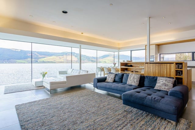 The floor to ceiling windows in the open-plan living space overlook the private beach.