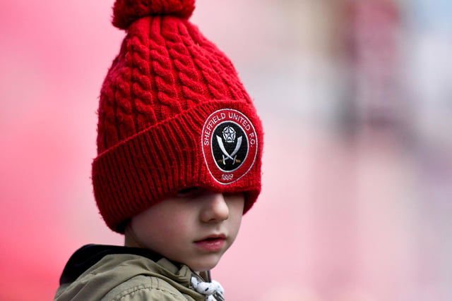 A young fan soaks up the atmosphere as the United players parade through the streets of Sheffield after finishing second in the Sky Bet Championship to gain promotion to the Premier League in May 2019.