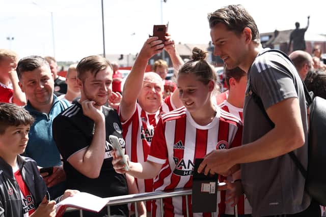A  fan takes a selfie with Sander Berge of Sheffield United: Darren Staples / Sportimage