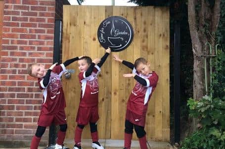 L-R: players Alfie West and Rocco Parr (Jayne's nephews) with Milo Fowler, pictured outside Time for Tea.