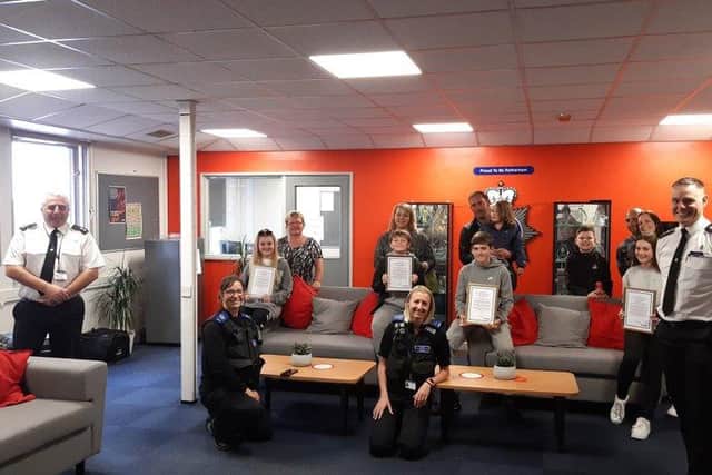 The children attended Main Street police station with their parents to collect their rewards.