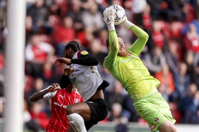 Viktor Johansson of Rotherham United saves from Mahlon Romeo of Portsmouth during the Sky Bet League One match between Rotherham United and Portsmouth at New York Stadium