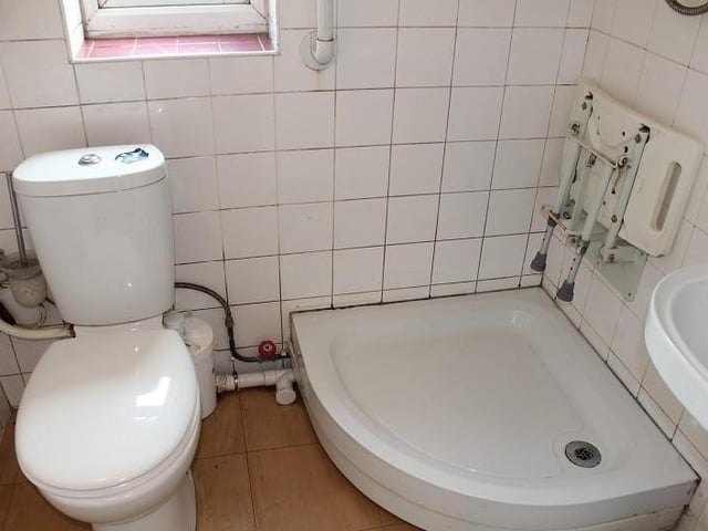 OK, it needs sprucing up, but the ground-floor bathroom boasts all you need. A shower tray is complemented by a pedestal wash hand basin and low-level WC.