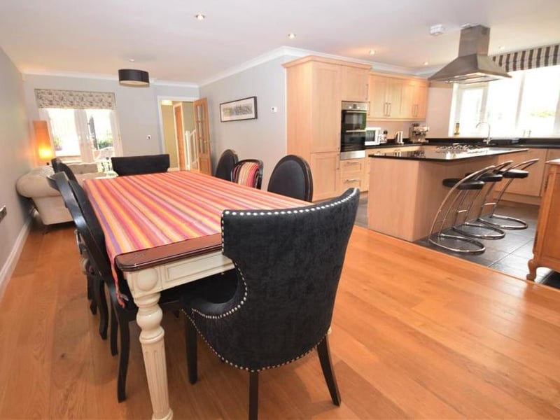 The impressive kitchen, suitable for the whole family. It is open plan and has neatly defined areas, including an ideal space for dining and also a relaxing living area.