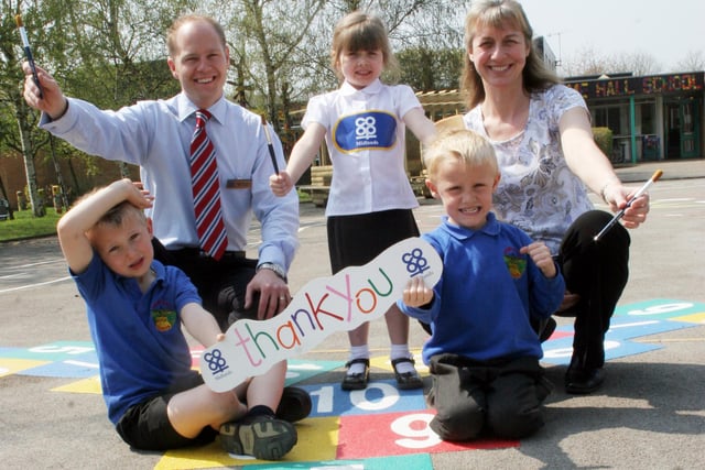 A donation from  Co op Money to paint play ground area at Holme Hall school in 2006,   l to r  Sam Robinson 5yrs. Christian Bradley Co op Manager, Jade Richards 5yrs, Isaac Dunwell 5yrs, Gillian Orwin Chair P T F A