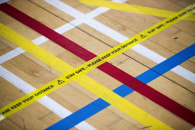 Tape that reads "Stay safe - Please keep your distance" on the floor at the Ravenscraig Regional Sports Facility in Motherwell,