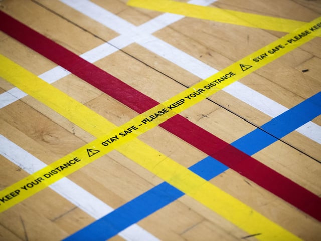 Tape that reads "Stay safe - Please keep your distance" on the floor at the Ravenscraig Regional Sports Facility in Motherwell,