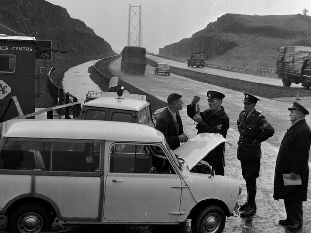 The RAC provide anti-freeze for motorists at the northern end of the Forth Road Bridge in December 1965.
