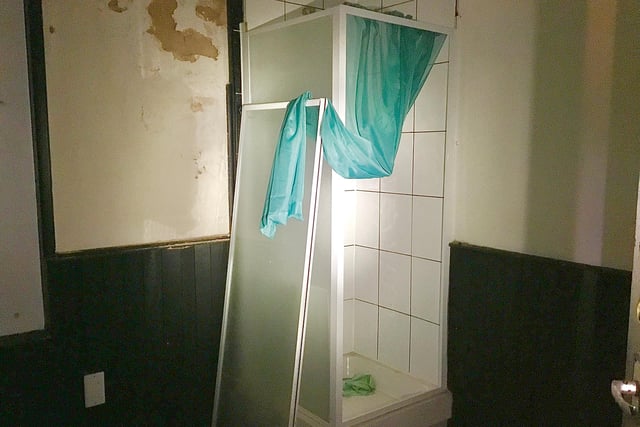 PIcture shows inside one of the rooms at the former City Sauna, with a shower cubicle