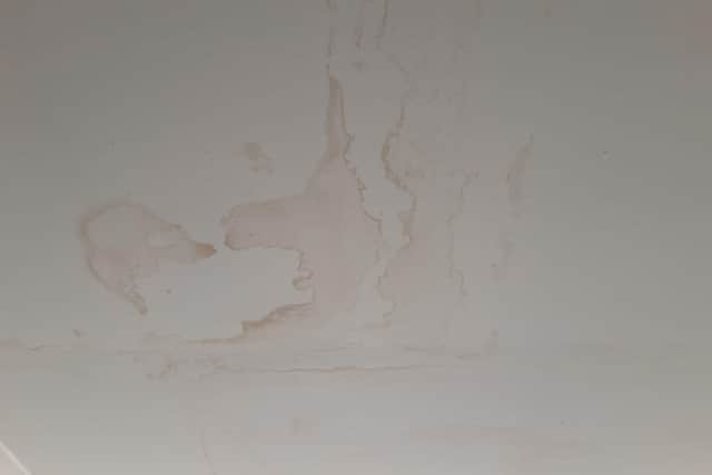 Water damage on the walls and ceiling of the property.