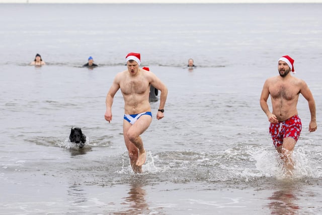 Fraser Lindsay and Matt Newman brave the waters at Portobello Beach, Edinburgh for a festive dip in Santa hats on Christmas Day.