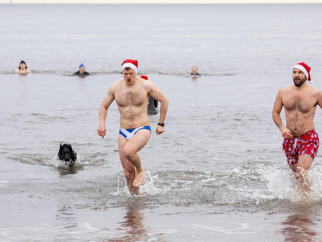 Fraser Lindsay and Matt Newman brave the waters at Portobello Beach, Edinburgh for a festive dip in Santa hats on Christmas Day.