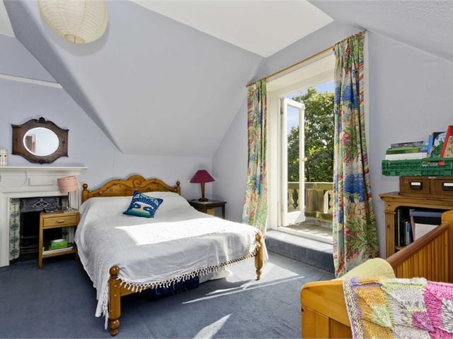 Bedroom 6 with French doors opening onto a stone-built balcony.