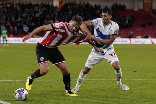 Sheffield United appealed for a penalty after Sander Berge saw his shirt tugged by Andre Dozzell in the closing stages of the Blades' defeat to QPR: Andrew Yates / Sportimage