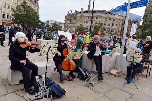 A string quarter plays Mozart to create a 'banker-ish vibe' at an Extinction Rebellion demo in Sheffield.
