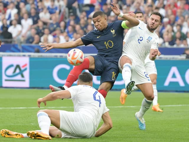 France's forward Kylian Mbappe (L) fights for the ball with Greece's defender George Baldock, who represents Sheffield United: ALAIN JOCARD/AFP via Getty Images
