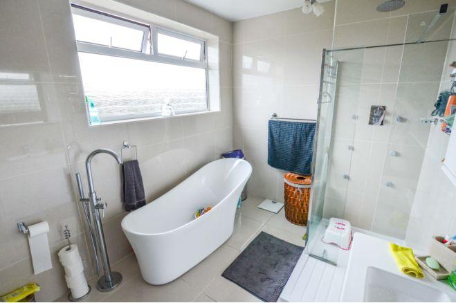 The brochure says: "A superb luxury bathroom includes free standing bath with separate floor standing tap, a double shower, vanity wash hand basin with mirror over and low flush WC.  There is a feature tiled wall.  Towel rail and central heating radiator.  Tiled flooring and walls."