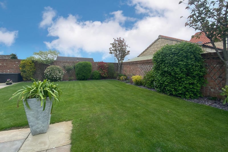 The rear garden is private and enclosed with retaining brick wall and fencing, gated access, outside security lighting, cold water tap and feature station lighting, established lawned garden with a variety of trees, shrubs, plants and seasonal flowers.