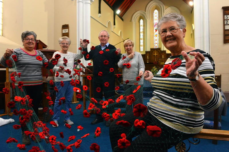 The All Saints Ladies Fellowship knitted poppies in 2018 for the All Saints Church service. Pictured from left are Ann Jeffrey, Linda Hughes, church warden Stuart Cameron, Doreen Crofts and Evelyn Gardner.