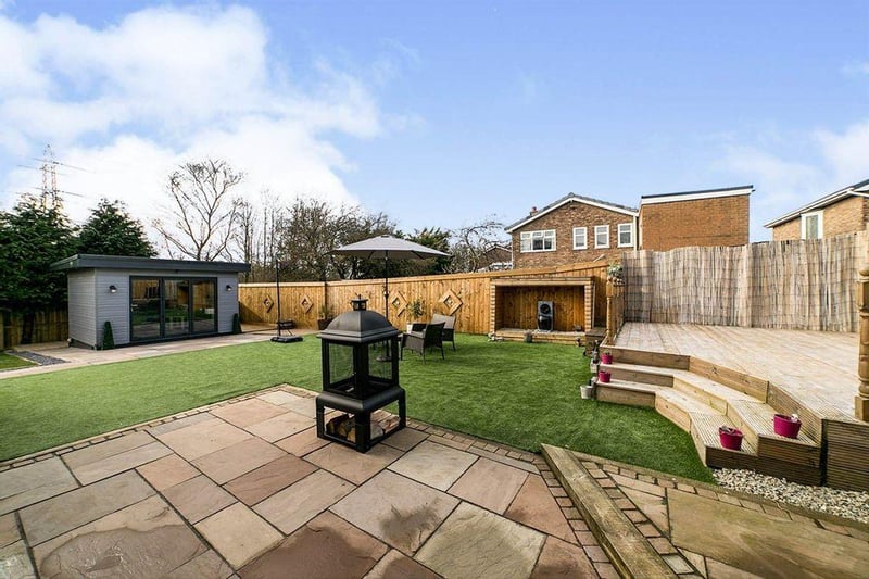 This spacious garden houses a block built summer house with patio area and decking.