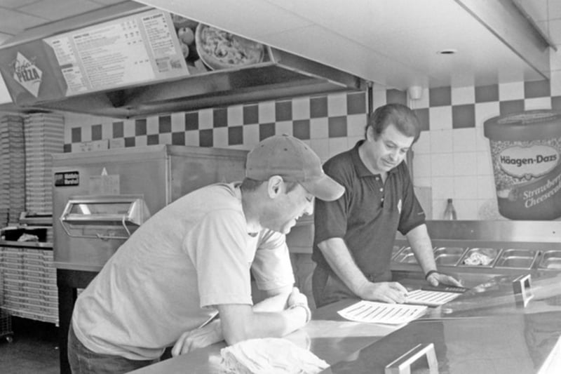 Owner Pelayias Petrov and assistant Zabeer Aslam at the Perfect Pizza takeaway shop, on Halifax Road, Parson Cross, Sheffield, in August 2004.