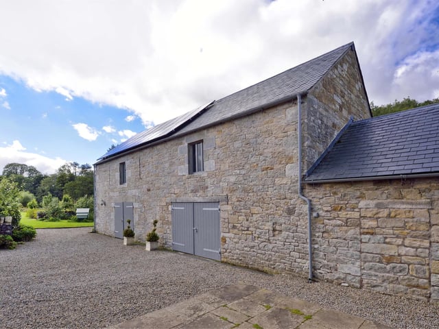 The two-storey barn next to the house, dating back to 1851, has been completely renovated and now comprises garage and stores on the ground floor with a large floored space suitable as a home office, games room or studio upstairs