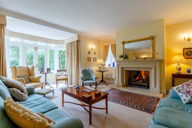 The spacious sitting room is bathed in natural light from the French doors which lead out into the garden, and a large stone Inglenook fireplace serves as the centrepiece of the room.
