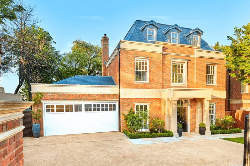 This stunning Wimbledon home is disguised by hedged walls and private gates - and could be all yours.