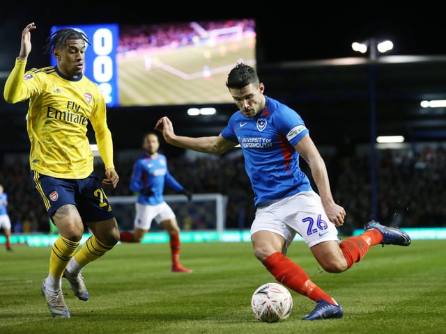 Portsmouth's Gareth Evans battles with Arsenal's Reiss Nelson in the first half