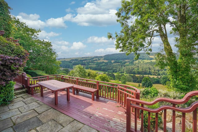 Another stunning part of this house is the incredible views you get over the valley beyond. This outdoor space is located just outside the kitchen area and offers views for miles.