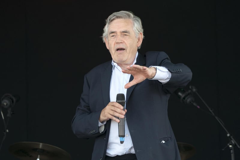 Former Prime Minister Gordon Brown speaks to the crowds and competitors at the Scottish Coal Carrying Championships in Kelty in Fife.  Picture date: Saturday August 28, 2021. PA Photo. The annual event is one of only two Coal Races in the world and the men's race requires participants to carry a 50-kilo bag of coal and the women's race requires a 25-kilo bag of coal to be carried over 1000 metres through the village. Photo credit should read: Jane Barlow/PA Wire 