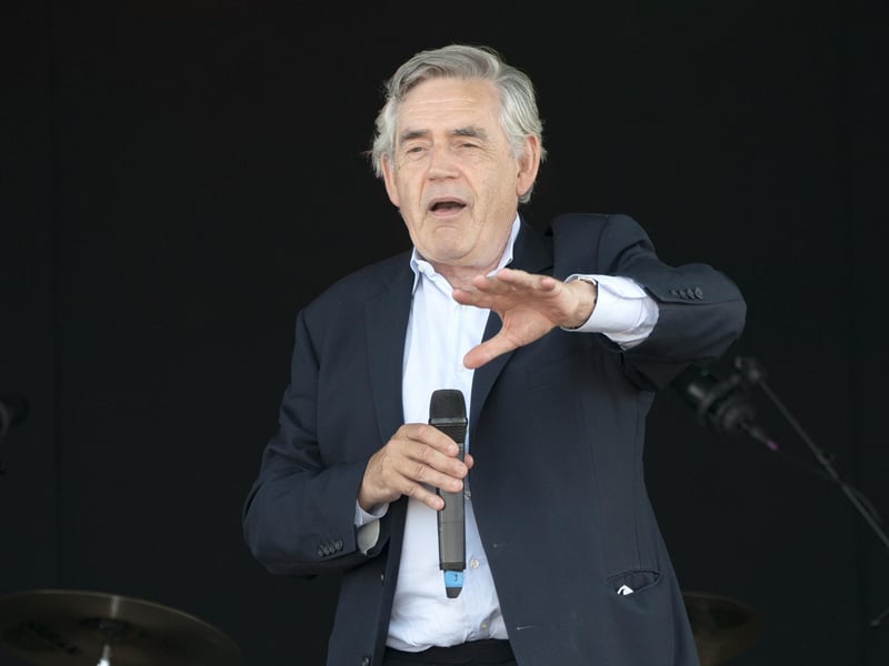Former Prime Minister Gordon Brown speaks to the crowds and competitors at the Scottish Coal Carrying Championships in Kelty in Fife. Picture date: Saturday August 28, 2021. PA Photo. The annual event is one of only two Coal Races in the world and the men's race requires participants to carry a 50-kilo bag of coal and the women's race requires a 25-kilo bag of coal to be carried over 1000 metres through the village. Photo credit should read: Jane Barlow/PA Wire