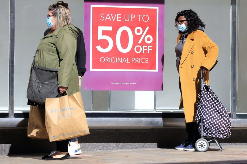Shoppers on The Moor, Sheffield with sales offers in the windows of Debenhams as stores reopen. Debenhams is one of the big names that has fallen victim to the pandemic, with the store set to close next month