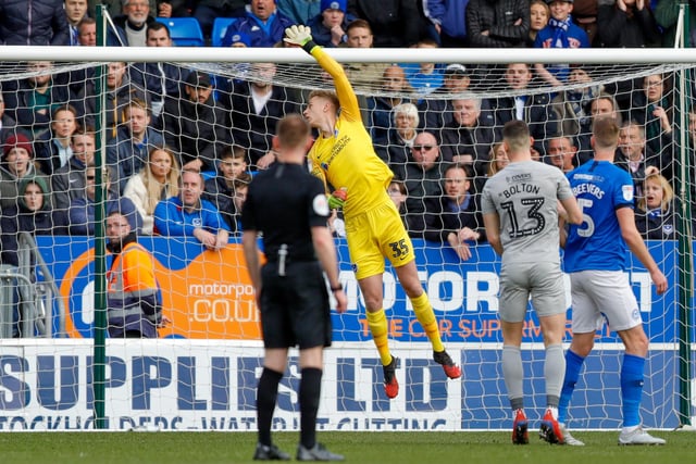 Pompey goalkeeper Alex Bass watches the ball go over