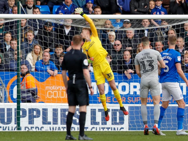 Pompey goalkeeper Alex Bass watches the ball go over