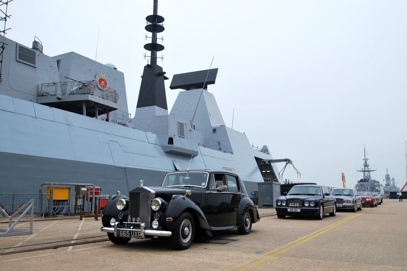HMS Defender and her Commanding Officer, Commander Phil Nash, played host recently to 40 members of the Rolls-Royce Enthusiasts Club (RREC) Southern Central Section, along with 15 of their beautiful motor cars.
The visit by the RREC was an ideal opportunity to show off the Royal Navys newest Type 45 destroyer which itself is Rolls-Royce powered, to members of the local community.