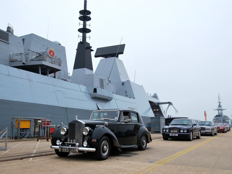 HMS Defender and her Commanding Officer, Commander Phil Nash, played host recently to 40 members of the Rolls-Royce Enthusiasts Club (RREC) Southern Central Section, along with 15 of their beautiful motor cars.
The visit by the RREC was an ideal opportunity to show off the Royal Navys newest Type 45 destroyer which itself is Rolls-Royce powered, to members of the local community.