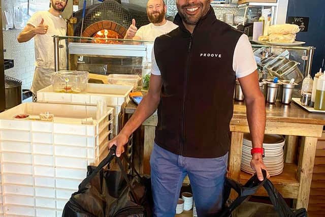 Deepak Jaiswal picking up a batch of wood-fired pizzas. Picture: Proove.