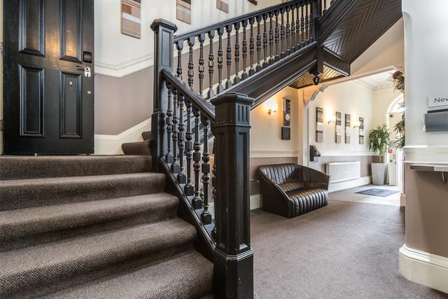 The welcoming entrance hall leads to a grand staircase