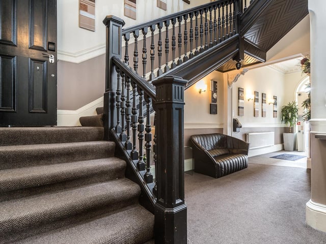 The welcoming entrance hall leads to a grand staircase