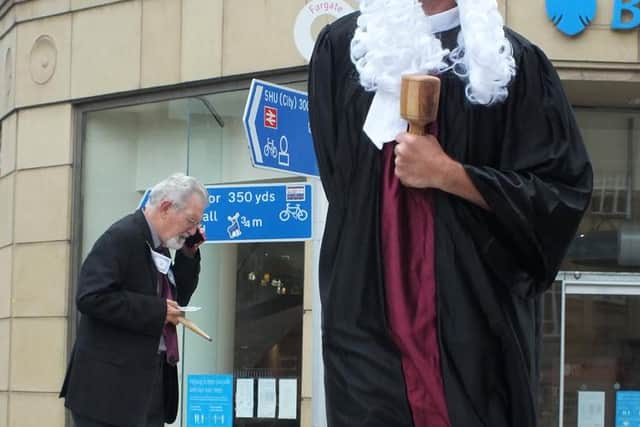 Richard dressed as a judge for Act Now's performance outside Barclay's last week