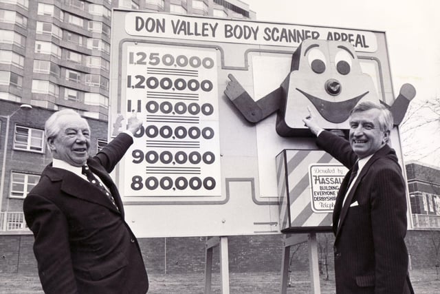 Royal Hallamshire Hospital, Sheffield
The Don Valley Body Scanner Appeal total reaches £1,328,500.  the Chairman of the Appeal, Peter Wood CBE (left) is seen here with the Honorary Treasurer, Ted Younger, Lloyds Bank plc, Church Street, with the "SAM THE SCAN" character created by the appeal - 1985