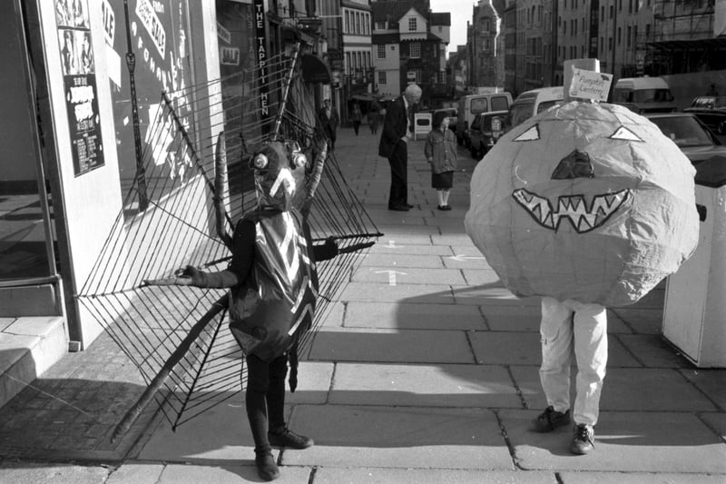 Fiona Kukk,(6) in spider costume with her friend dressed as a pumpkin lantern for the Guisers Parade on Edinburgh's Royal Mile, a highlight of the Guys and Guisers programme of performing arts specially for children around Halloween, October 1988.